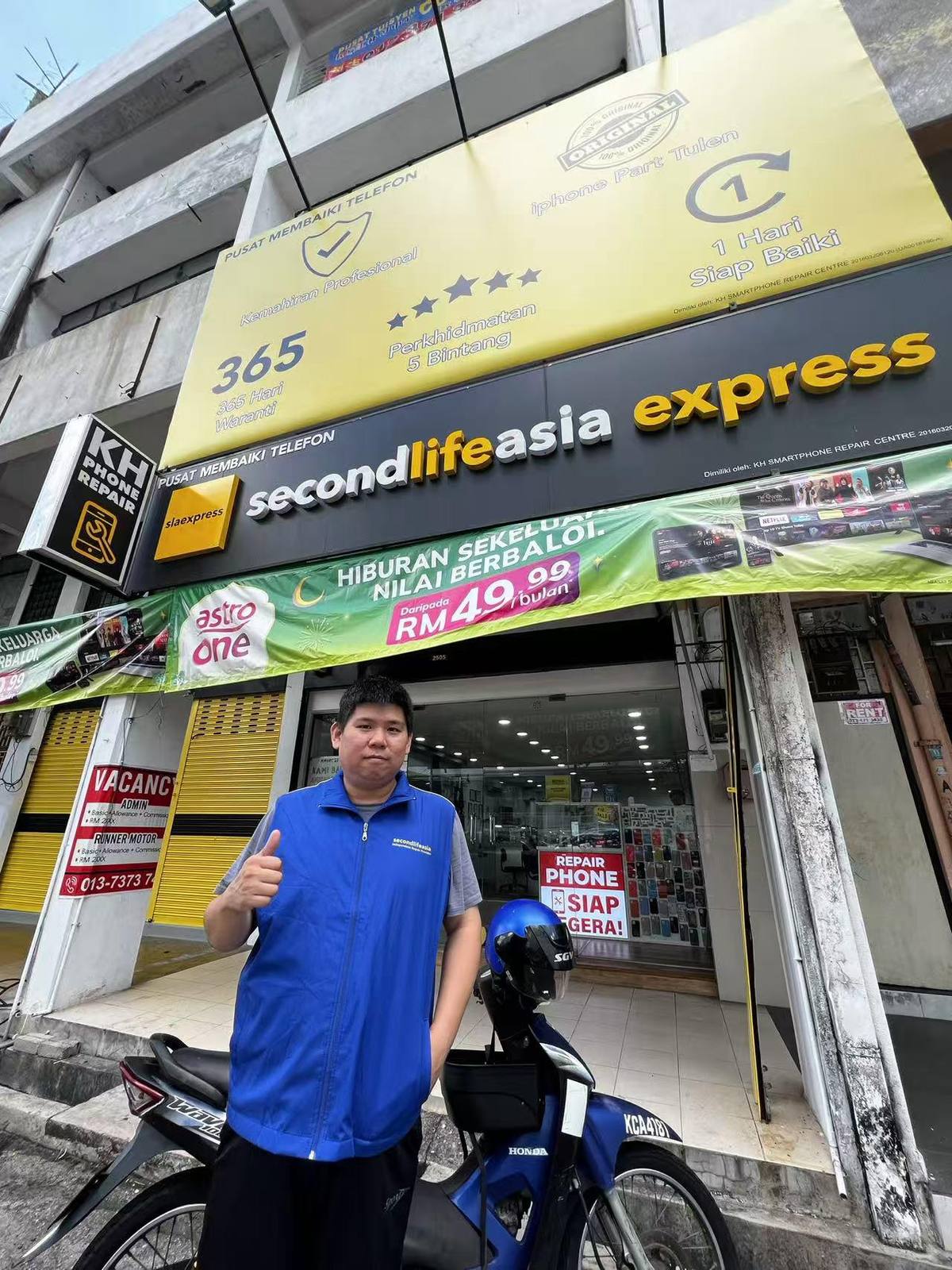 Tan Pin Heng in front of his KH repair shop